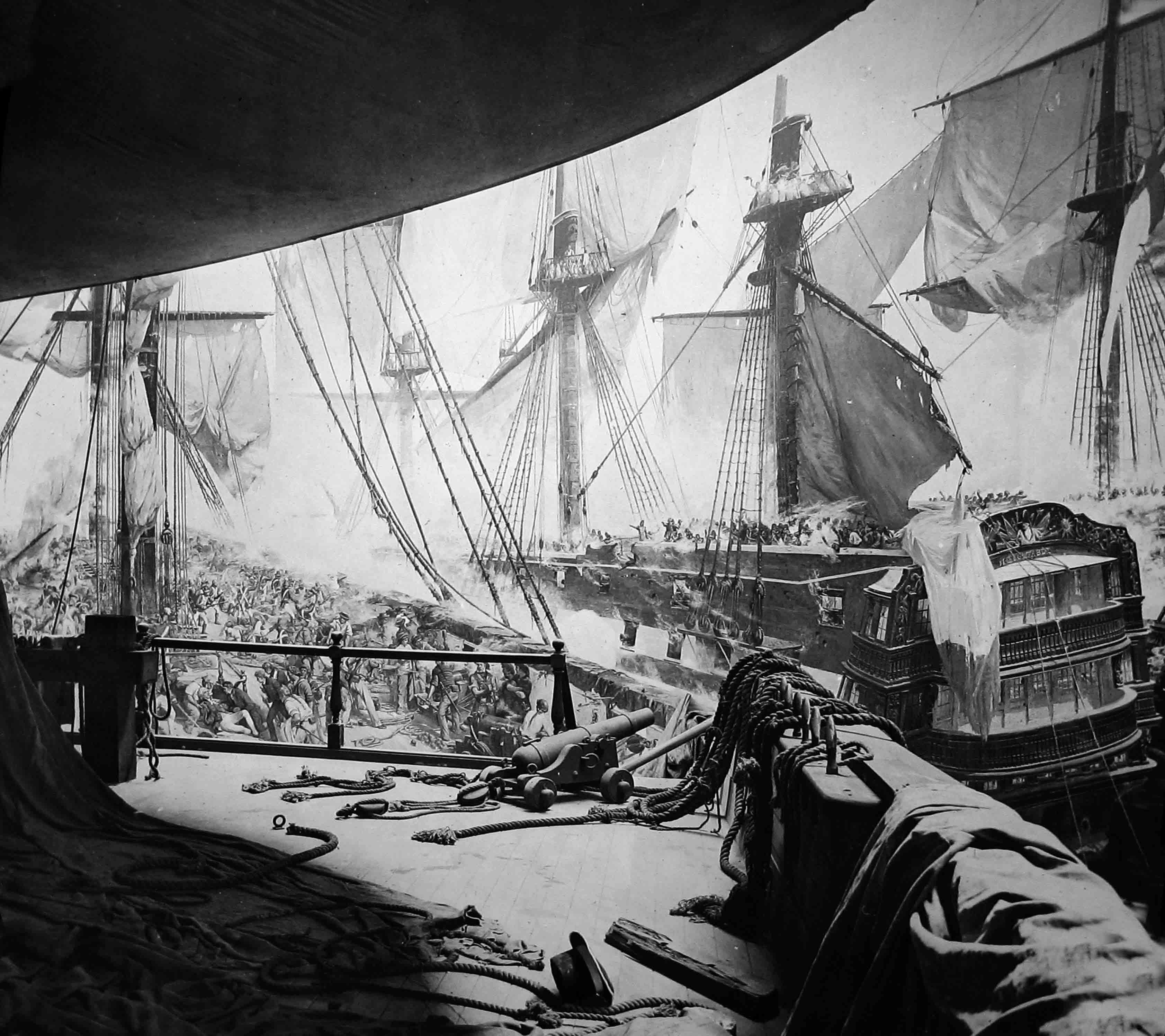 A panorama display of the Battle of Trafalgar with canons and ropes in the foreground.