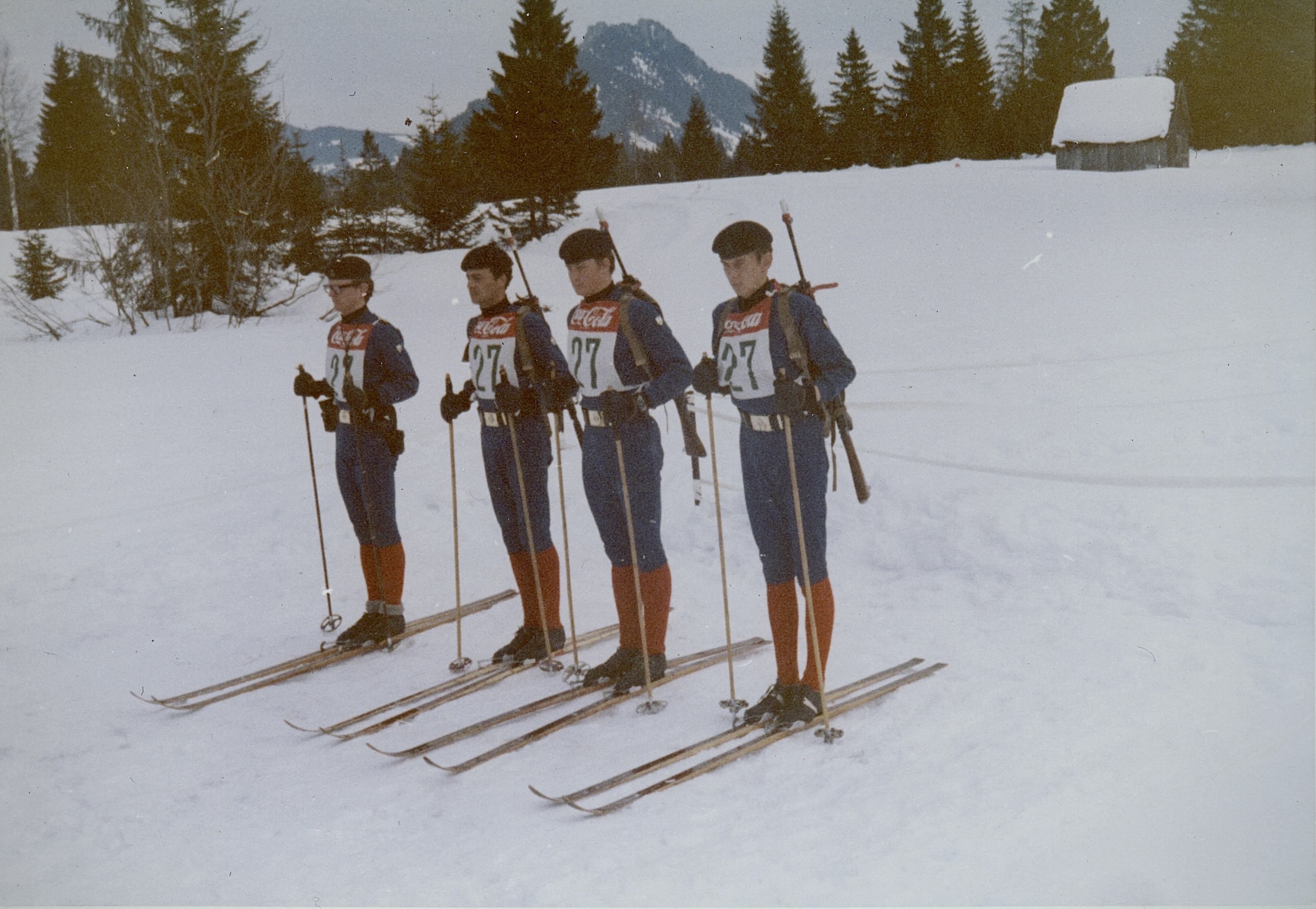 Four men stood in a line skiing at the Army Championships for cross-country skiing