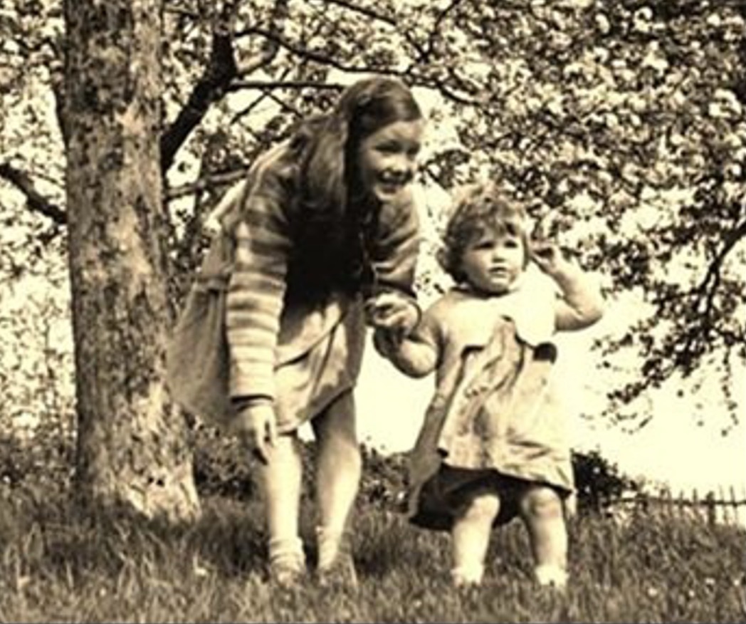 Little Janet with her sister Jane, in the orchard near her home