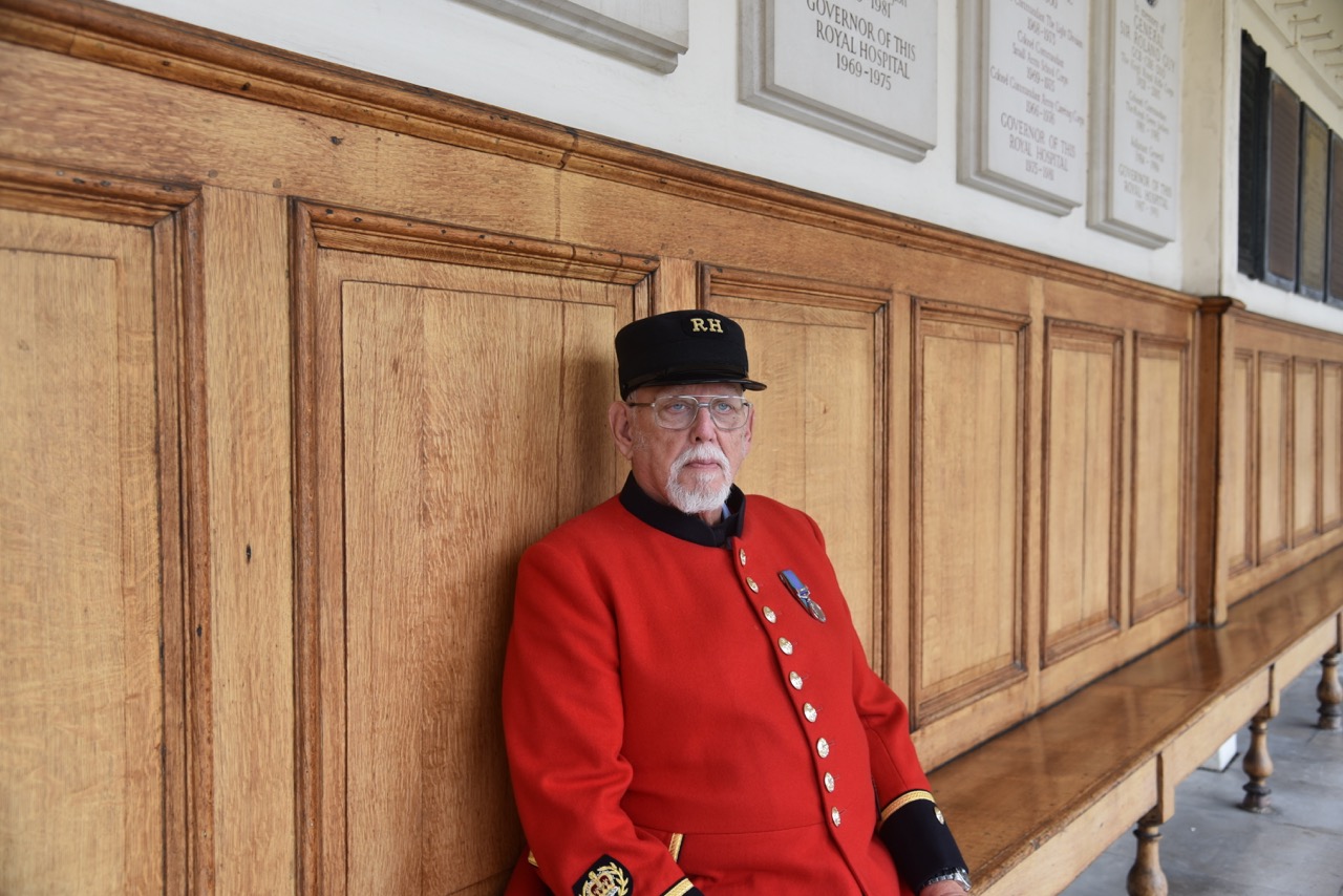 Chelsea Pensioner Peter Turner sat outside in Scarlet uniform