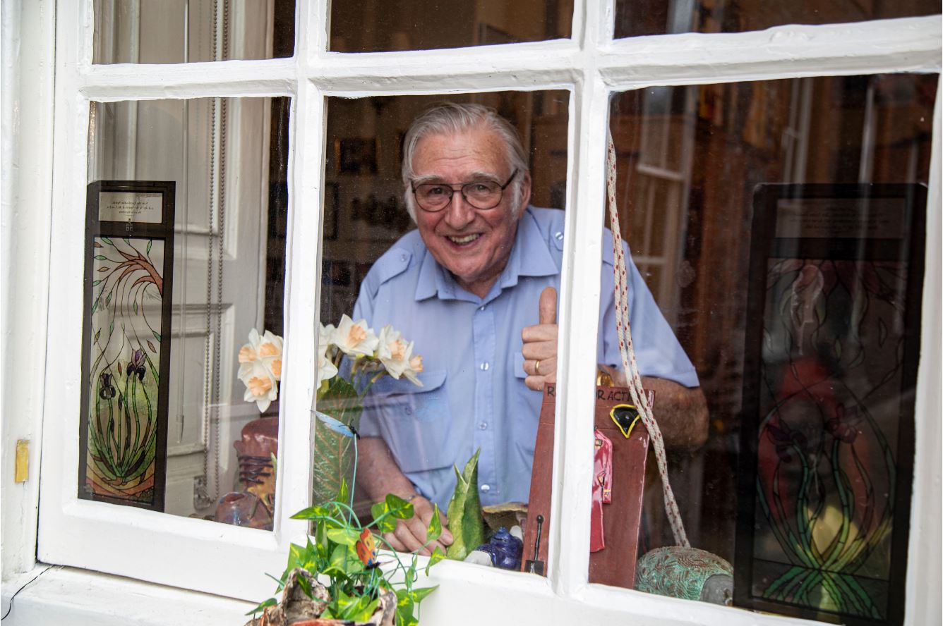 Pensioner Ray Pearson gives thumbs up from berth window