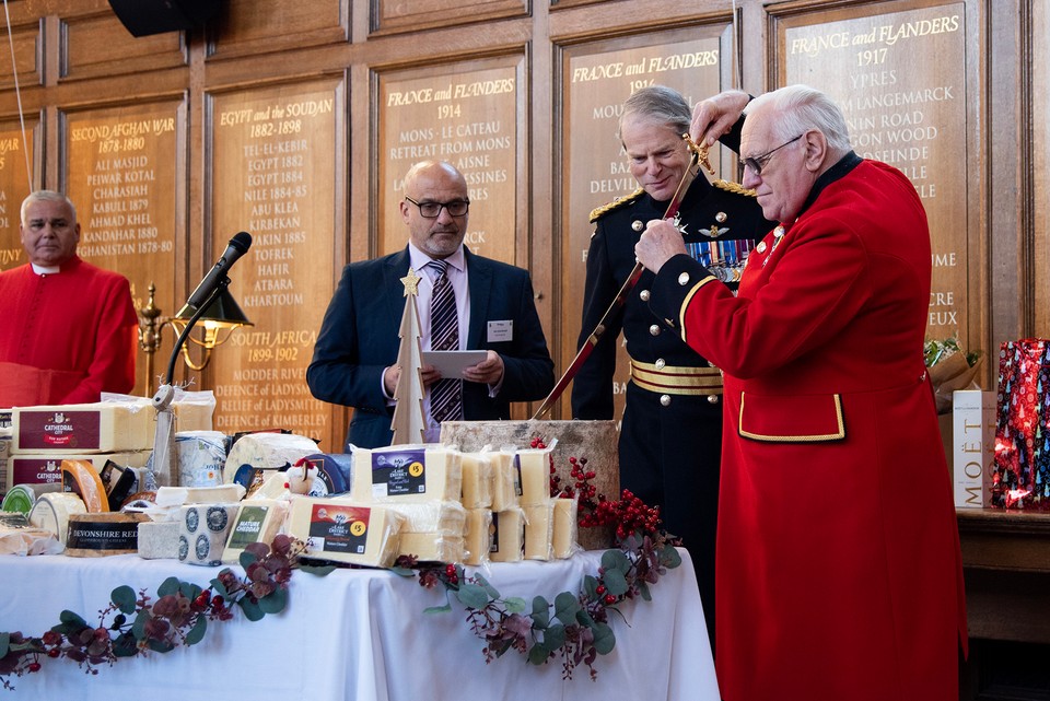 Chelsea Pensioner Mike Allen cuts the ceremonial Christmas cheese