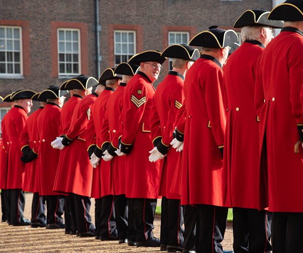 Chelsea Pensioners stood in a line in scarlet uniform
