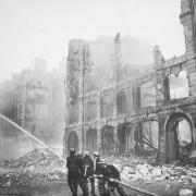 Firefighters amidst rubble in London during the Blitz