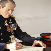 Governor, General Sir Adrian Bradshaw signing the Armed Forces Covenant
